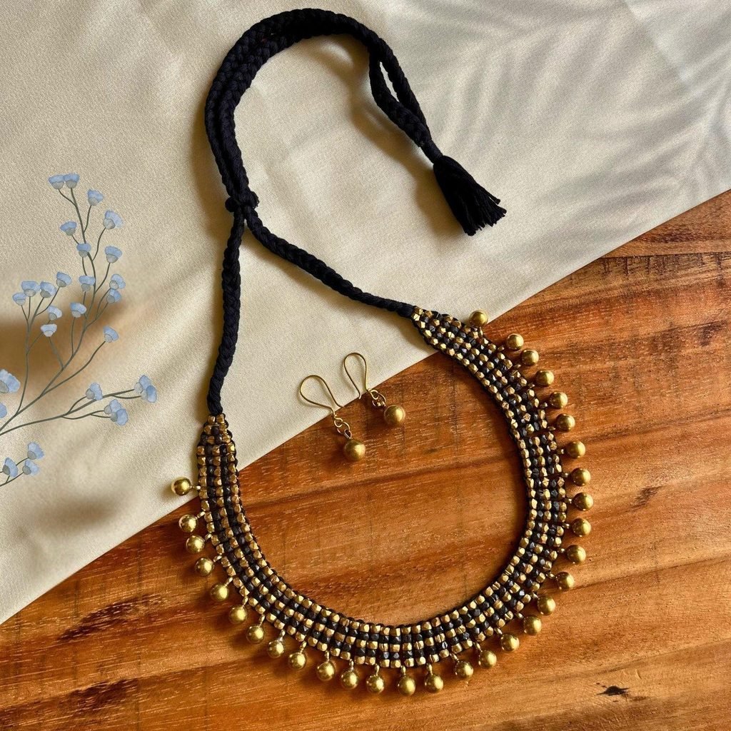 Handmade brass bead and macrame necklace requiring gentle dry cleaning
