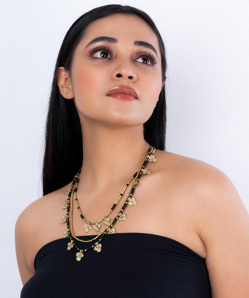 Woman wearing a handcrafted brass statement necklace styled with western attire